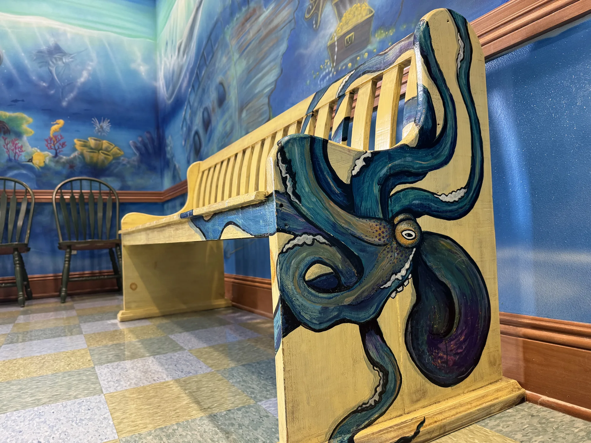 Hand-painted octopus detail on the underwater waiting room mural
