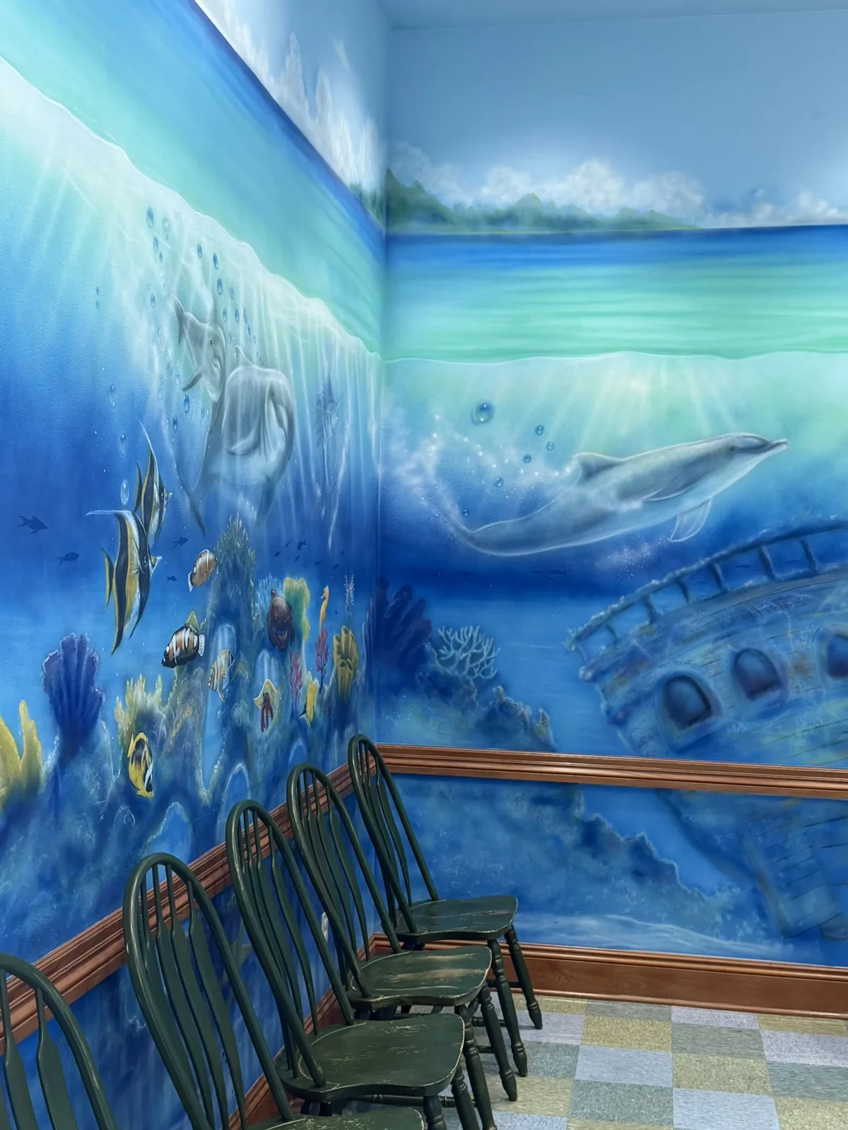 The ocean-themed waiting room at Preferred Pediatrics, with an undersea mural above rows of chairs